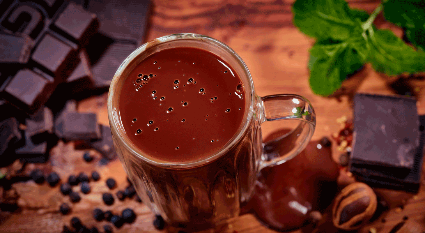 Image: a top-down view of a cup of hot chocolate on a table 