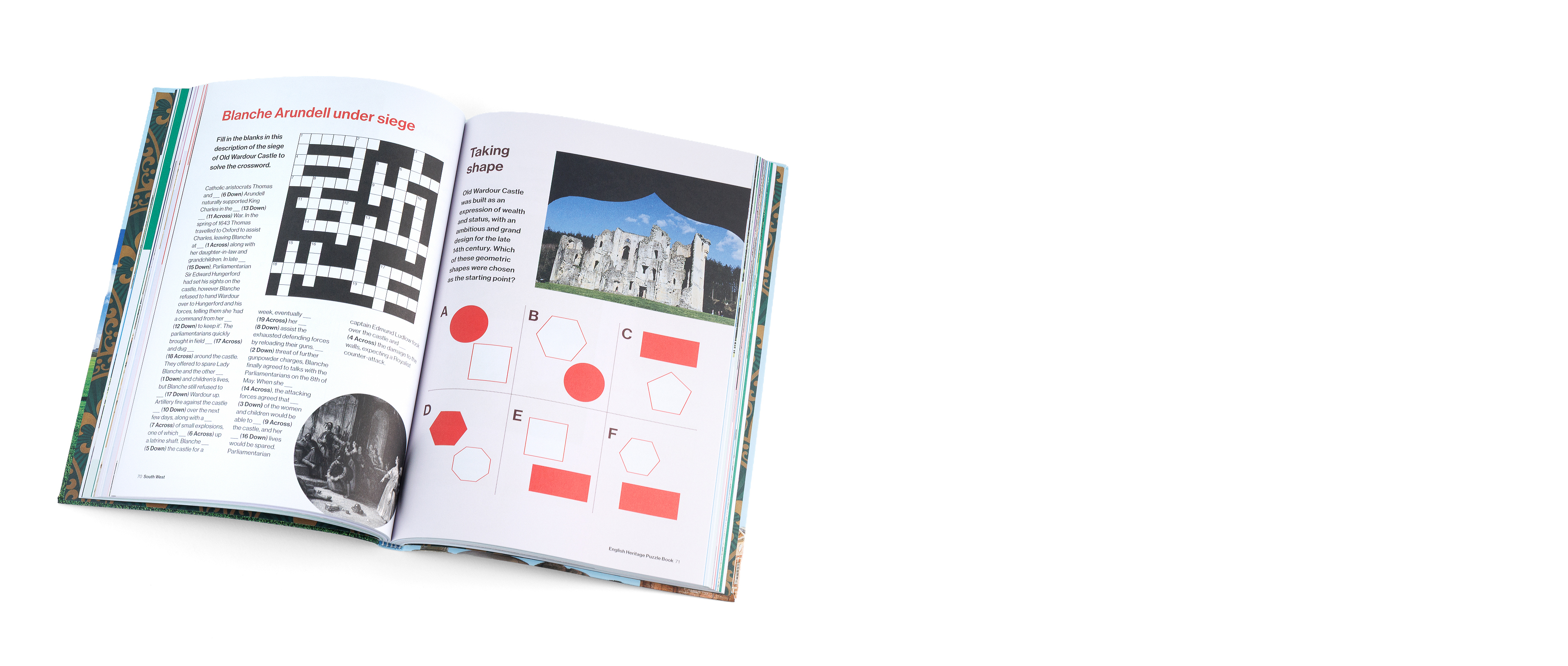 The English Heritage Puzzle Book is laid open on a plain white background. The pages feature a crossword and an image of a castle ruin