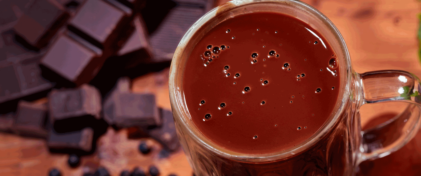Image: a top-down view of a cup of hot chocolate on a table