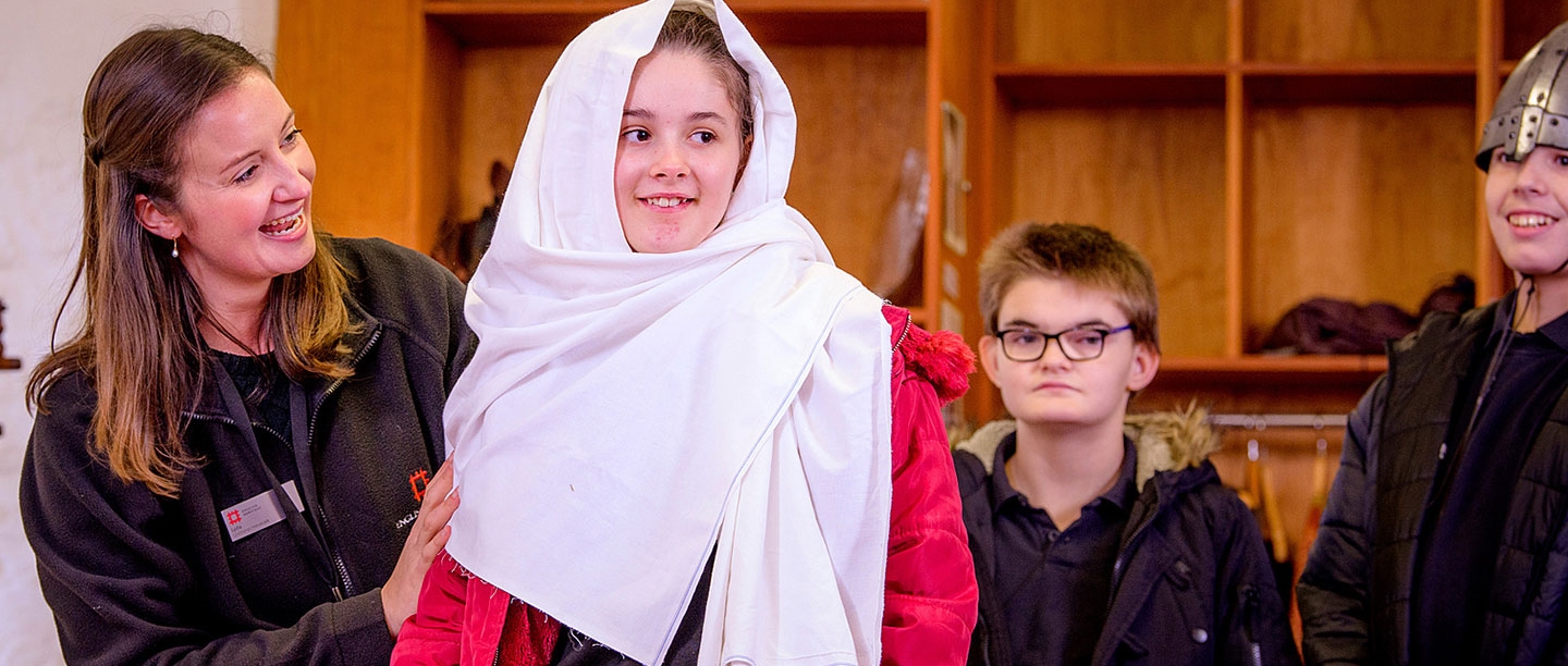 A girl in historical dress learns about history