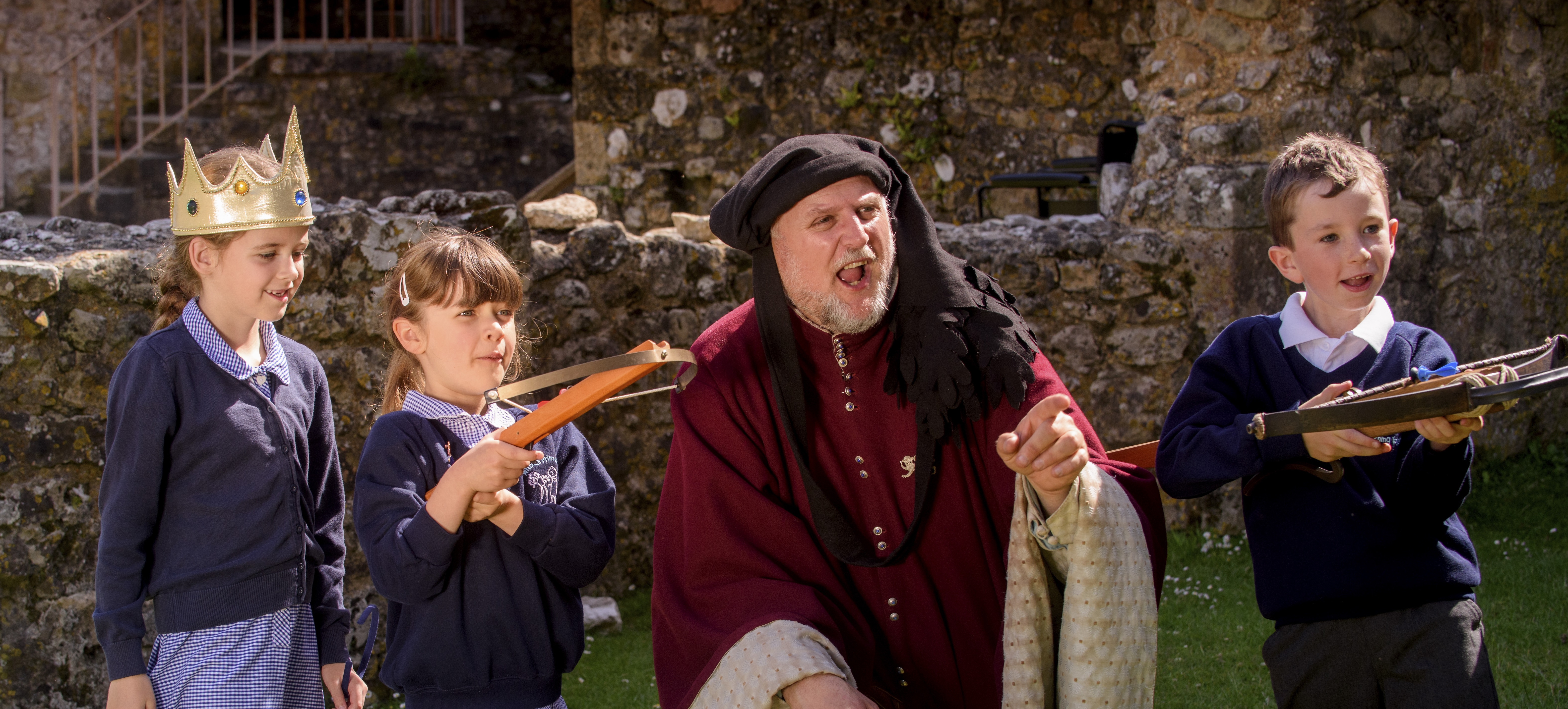 A man dressed as a medieval lord with a group of students