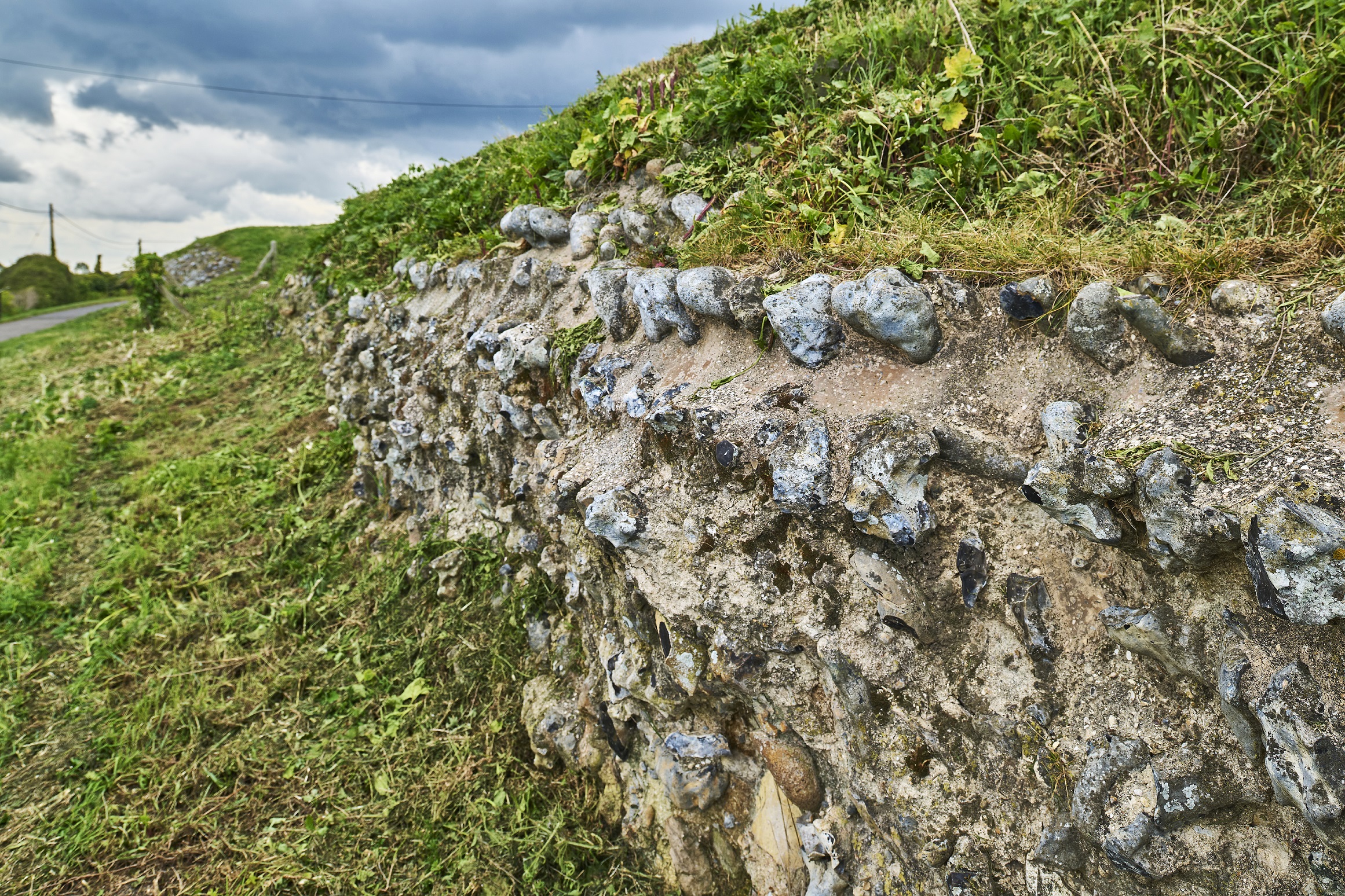 Photo of a Roman-era wall covered with grass