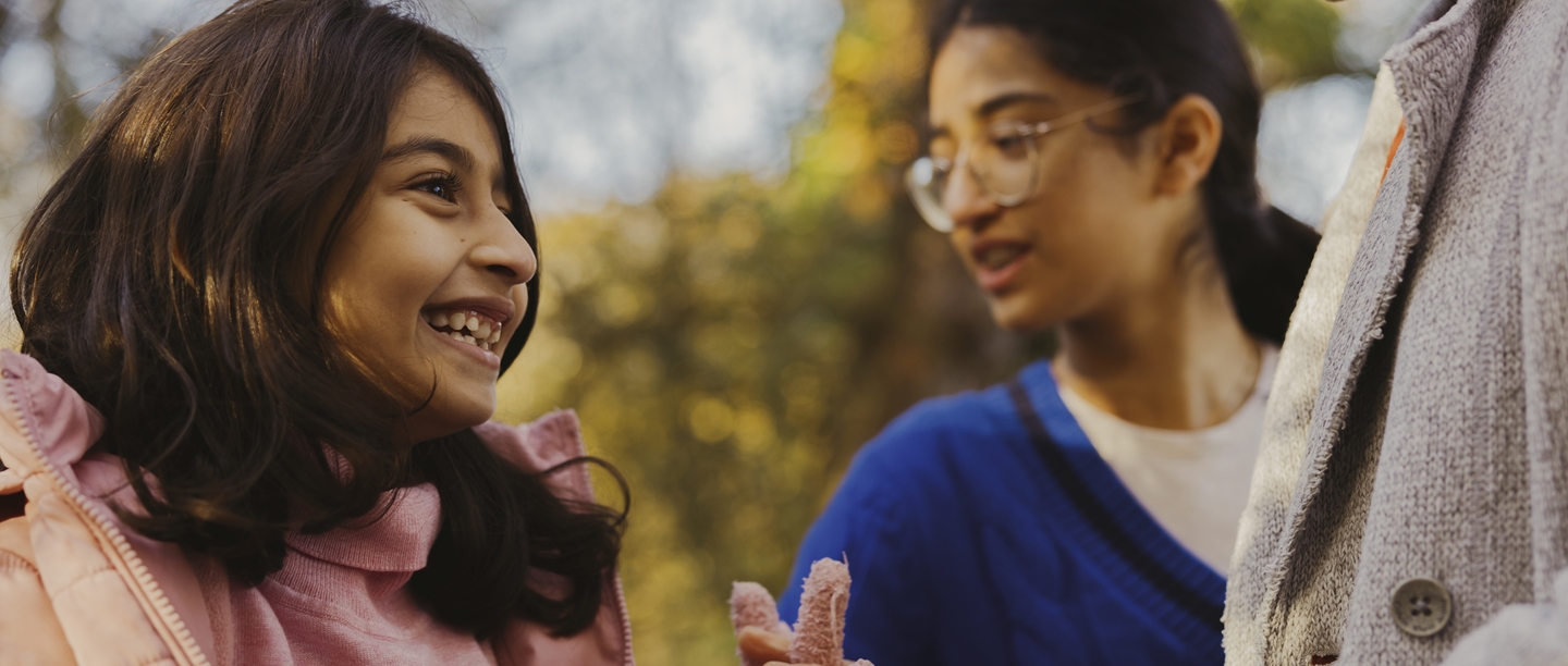 Photo of a child wearing a pink jacket and smiling
