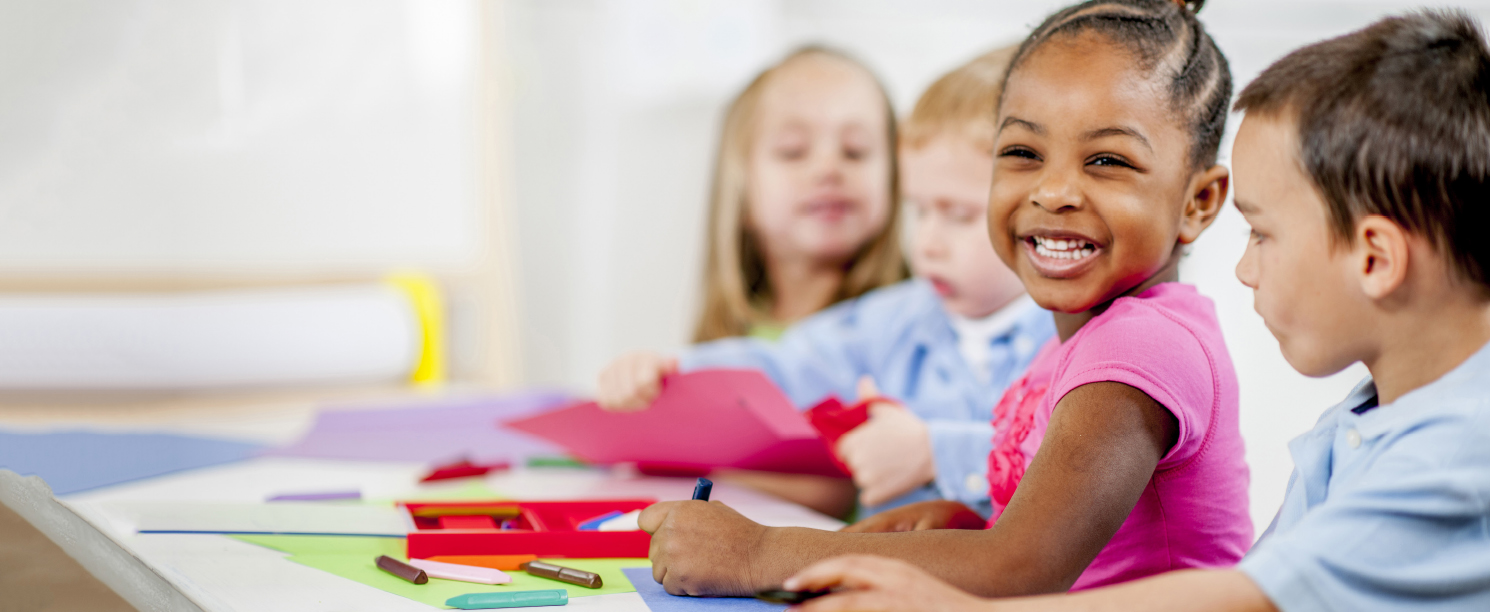 Young children making birthday cards
