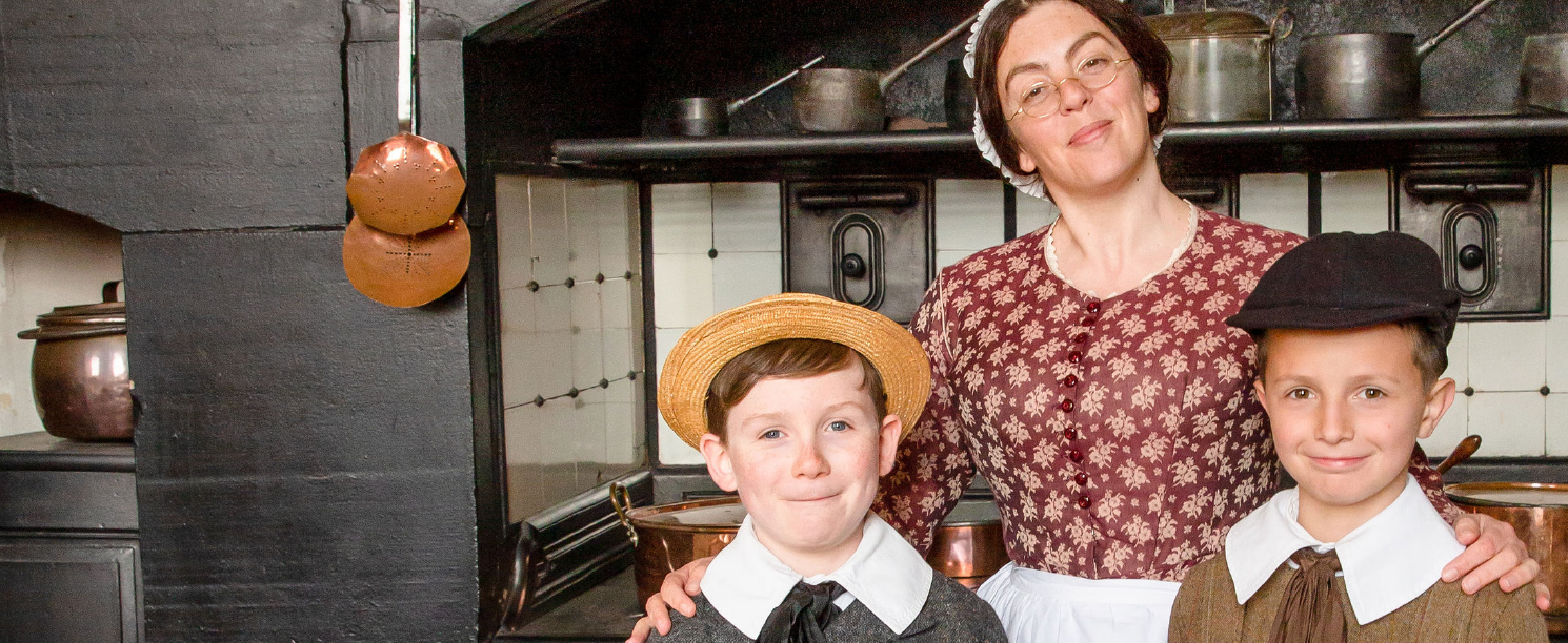 Mrs Crocombe and two young English Heritage members in Victorian period dress
