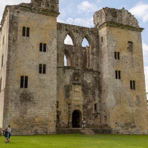 Photo of the enormous keep of Old Wardour Castle with a family looking up at it