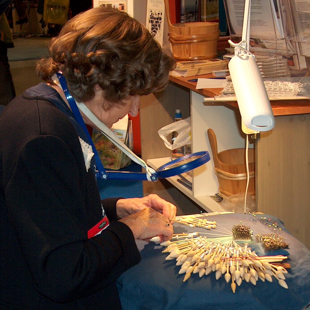 Photo of someone doing bobbin lacemaking