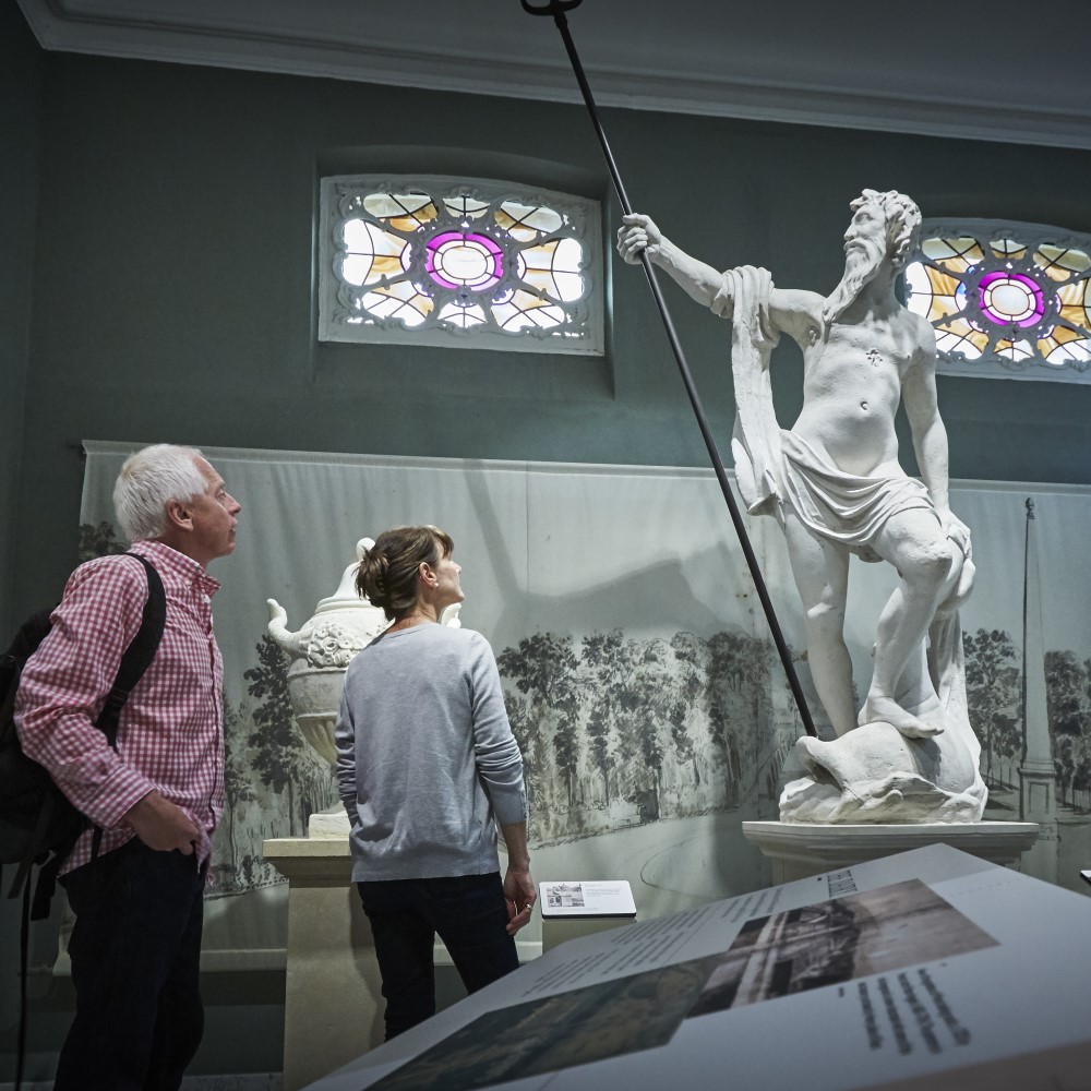 Photo of two visitors looking at a statue in a room at Wrest Park