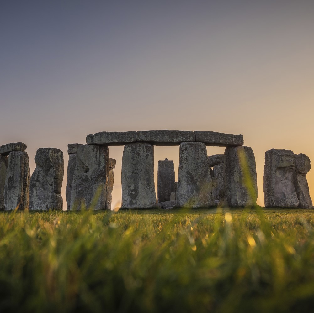 Photo of Stonehenge with the sun rising behind the stones