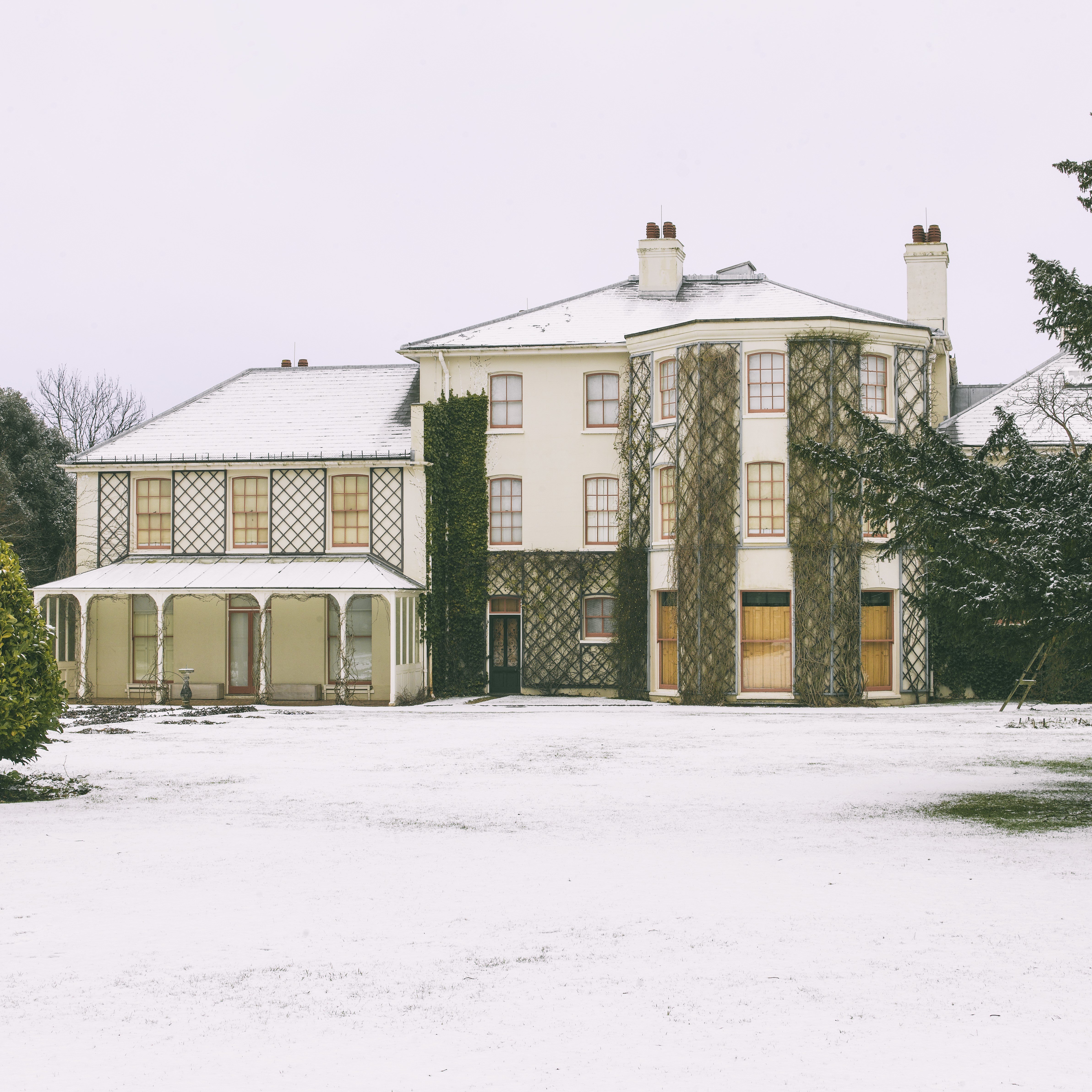 Photo of Down House and its gardens covered in snow