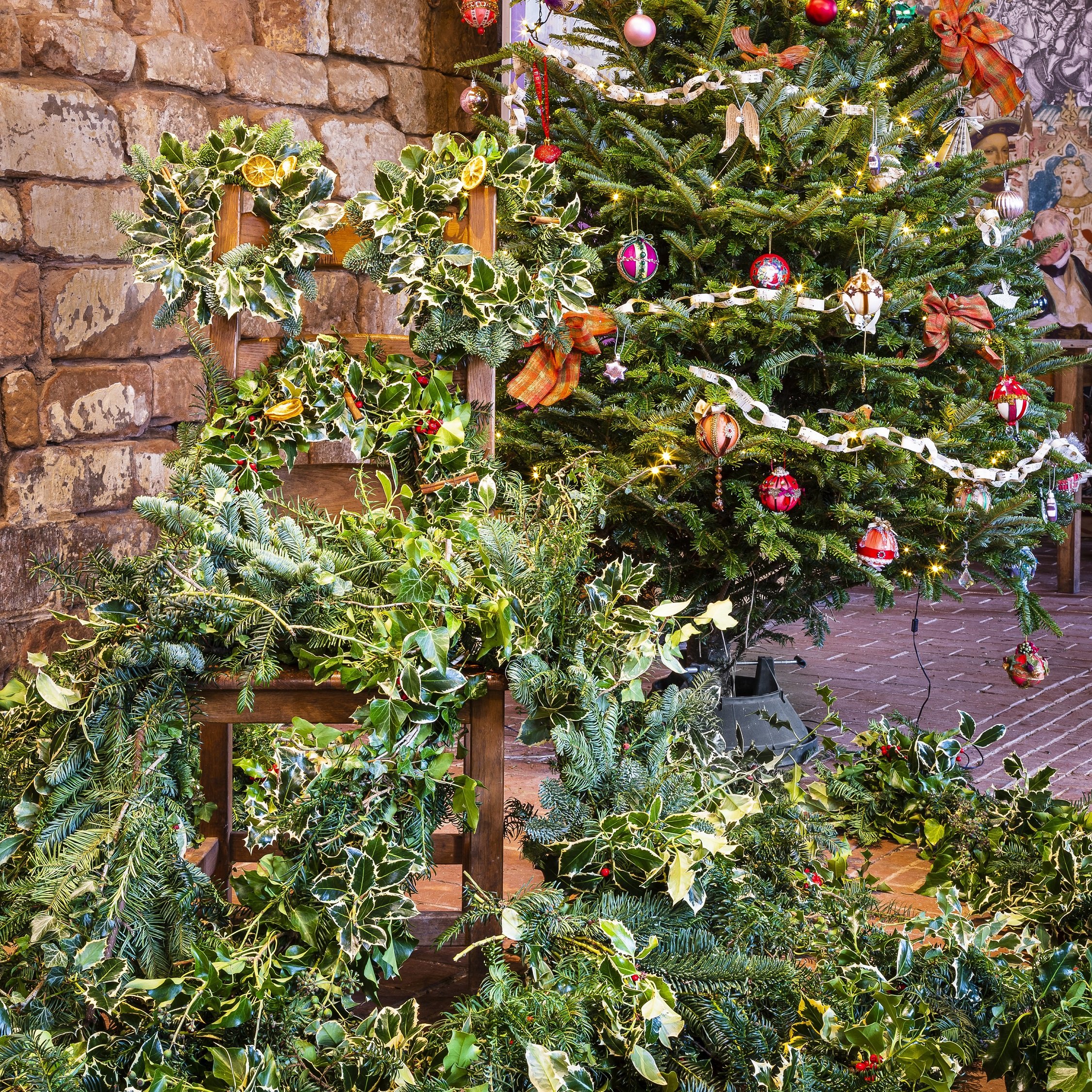 Photo of Christmas wreaths and a Christmas tree in a castle