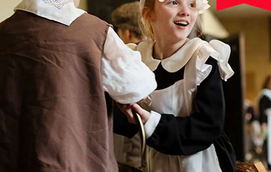 Image: children trying on Victorian-style clothes