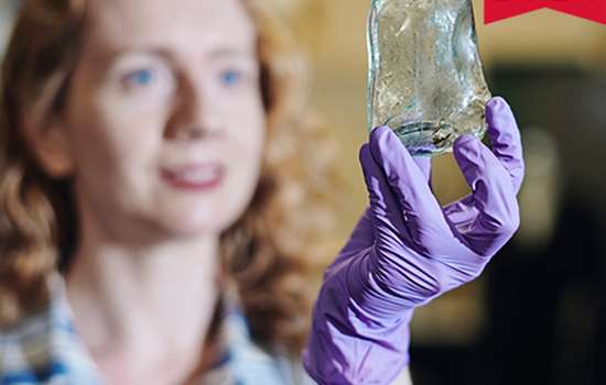 Image: Dr Kathryn Bedford holds up glass object