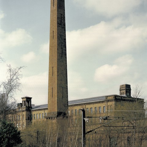 Photo of a mill with a tall chimney in Saltaire, West Yorkshire