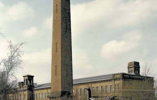Photo of a mill with a tall chimney in Saltaire, West Yorkshire