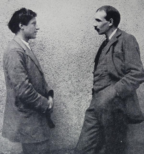 Grainy black and white photography of the painter Duncan Grant standing with economist John Maynard Keynes
