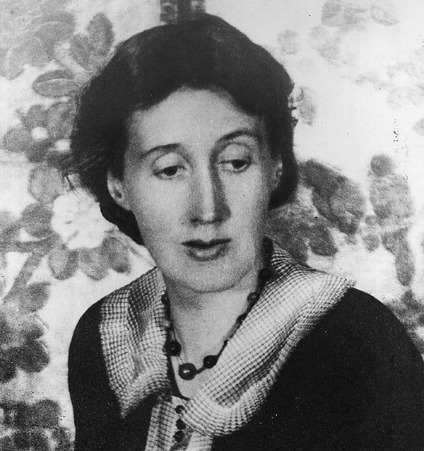 Grainy black and white photograph of Virginia Woolf looking down to the right of frame