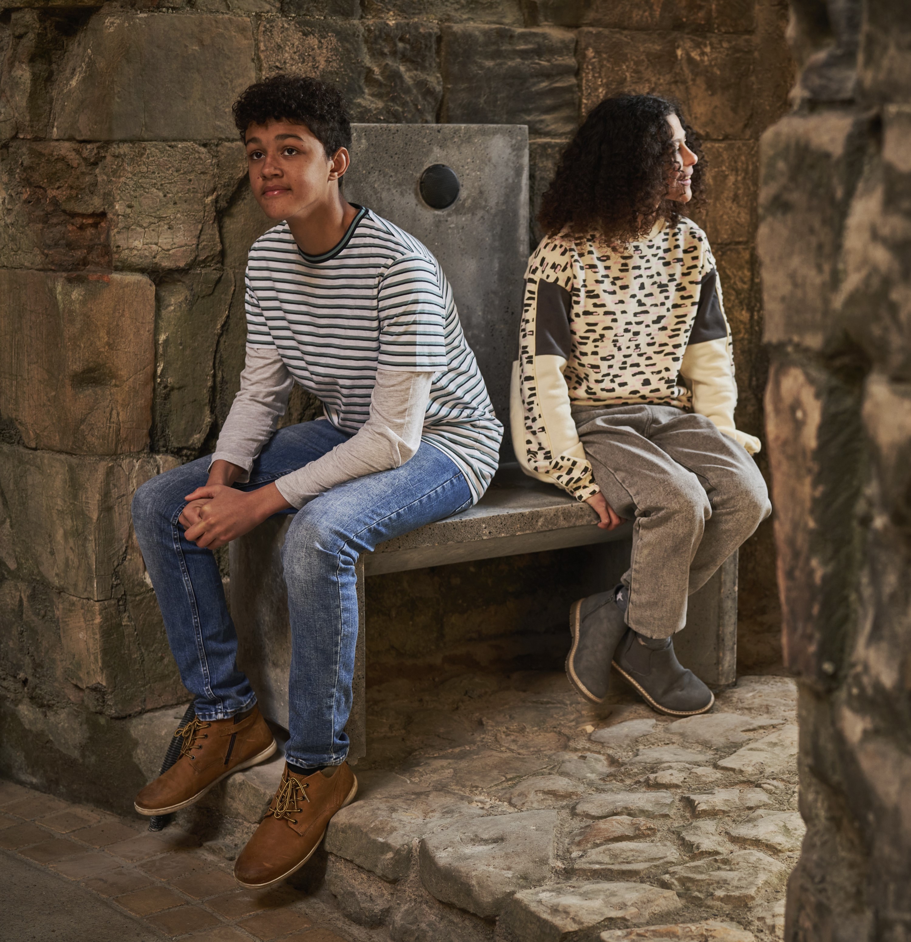 Image: Two children sat listening to an audio installation at Clifford's Tower in York