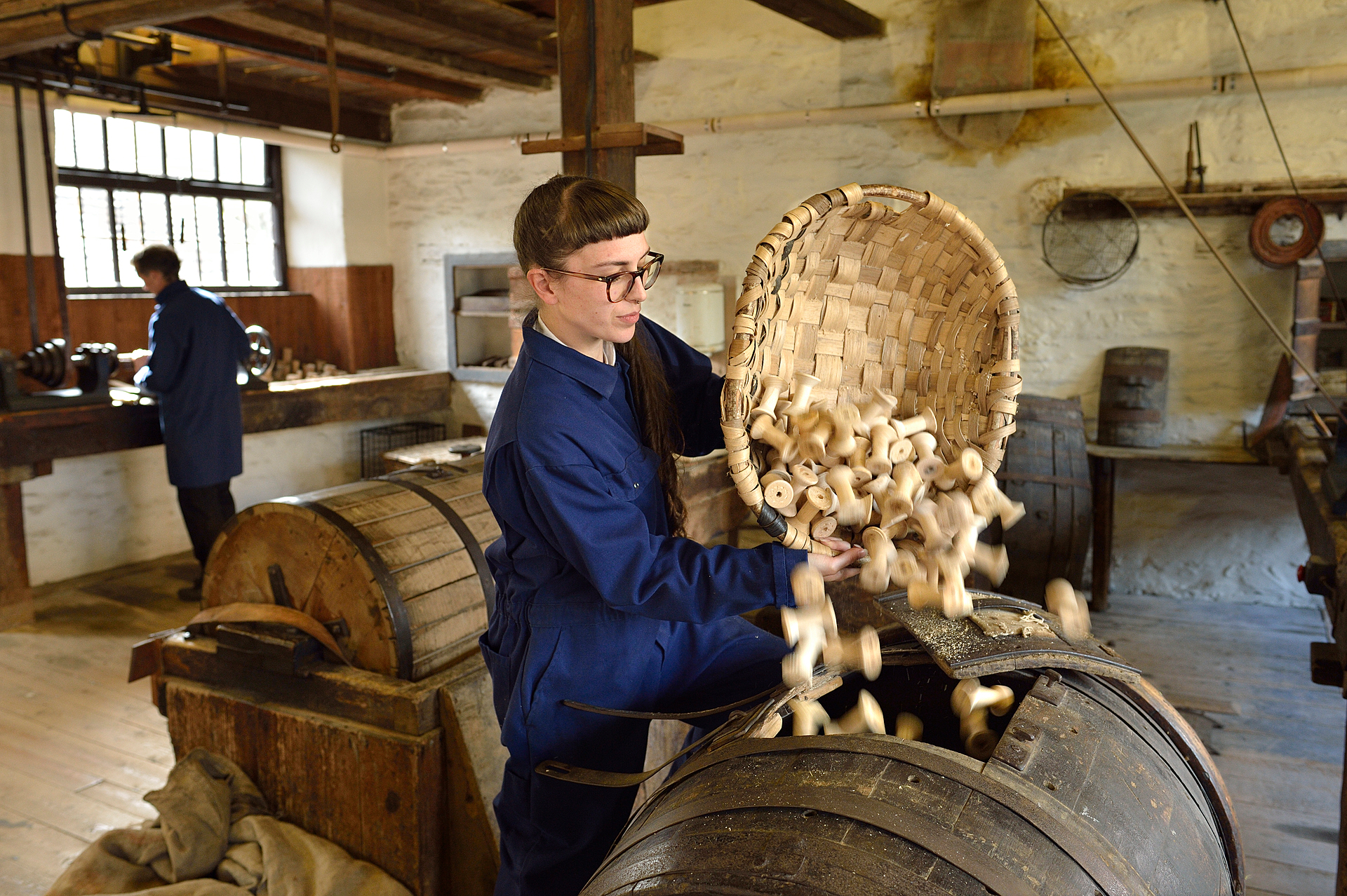 Image: staff member uses bobbin making machine