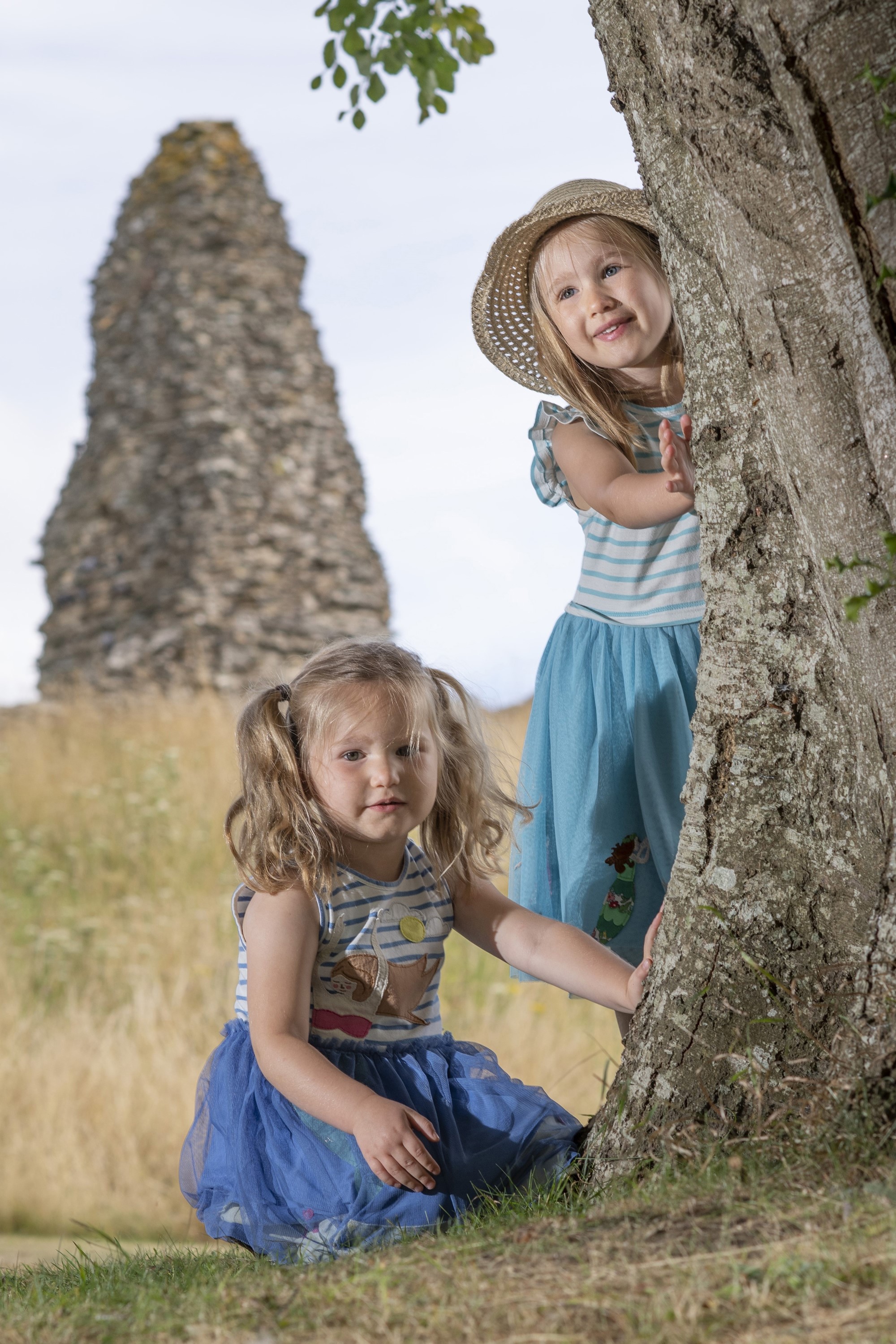 Image: Two children touch the bark of a tree at Launceston Castle