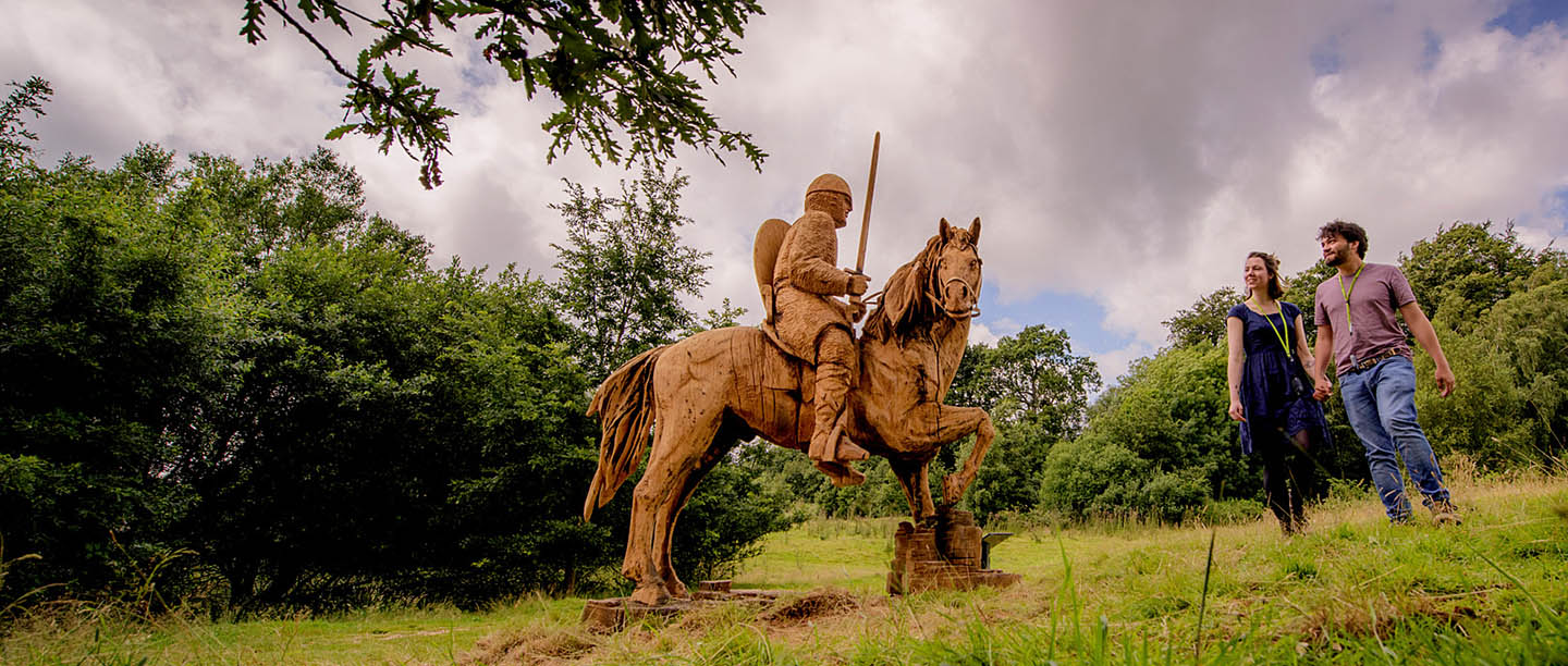 A couple look a sculptures on the 1066 Battlefield