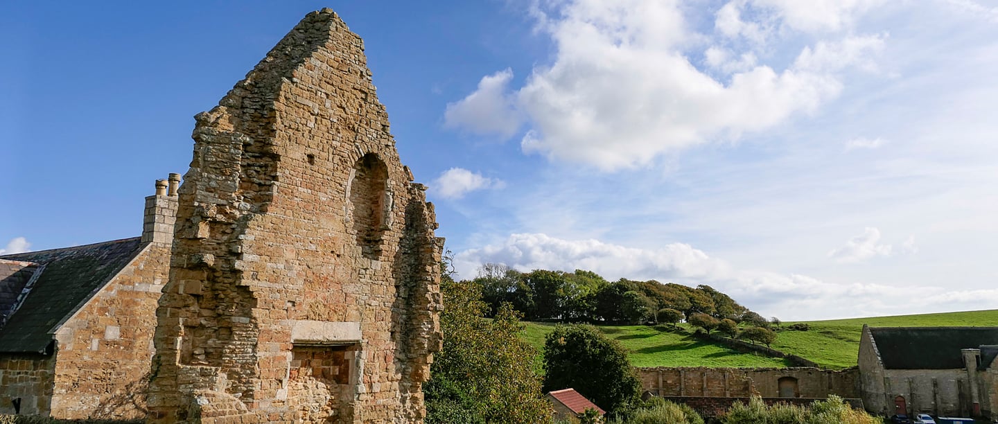 A large stone wall which are part of the remains of Abbotsbury Abbey.