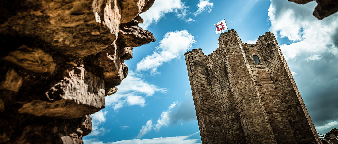 Conisbrough Castle keep viewed through a stone archway