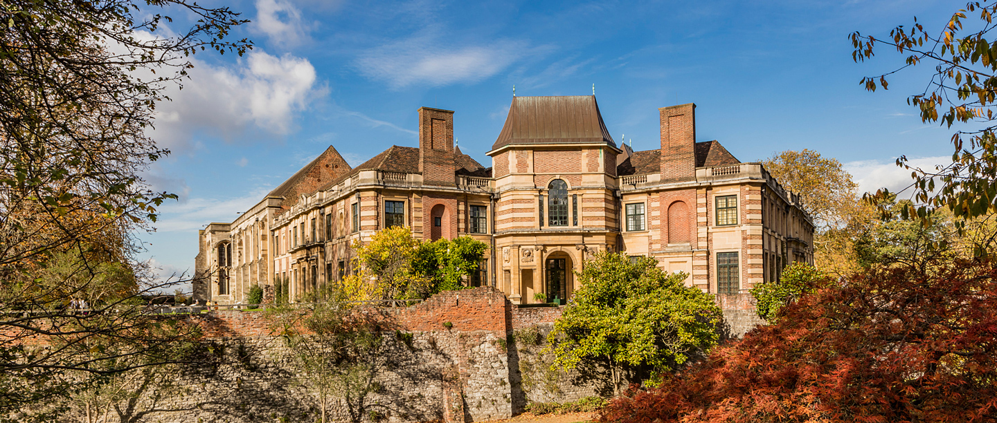 The exterior of Eltham Palace underneath a blue sky.