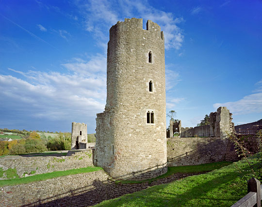 The tall south-west tower in the inner court at Farleigh Hungerford Castle, with remains of other walls stretching into the distance