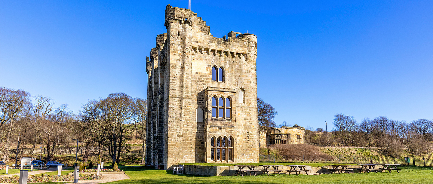 A castle tower with large glazed windows