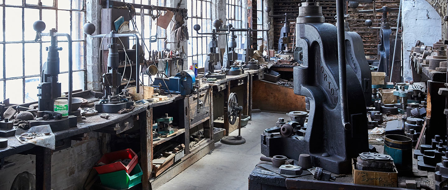 A selection of fly presses in the workshop at J.W. Evans Silver Factory