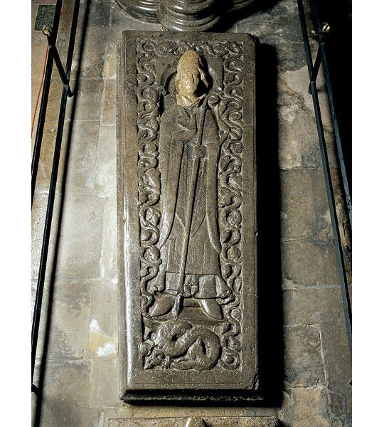 The Tournai marble tomb slab of Bishop Roger in Salisbury Cathedral with beautifully carved effigy standing above a dragon, Old Sarum