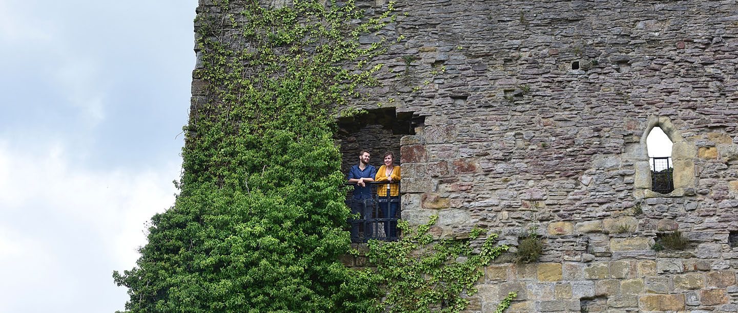 Visitors looking out a window at Richmond Castle