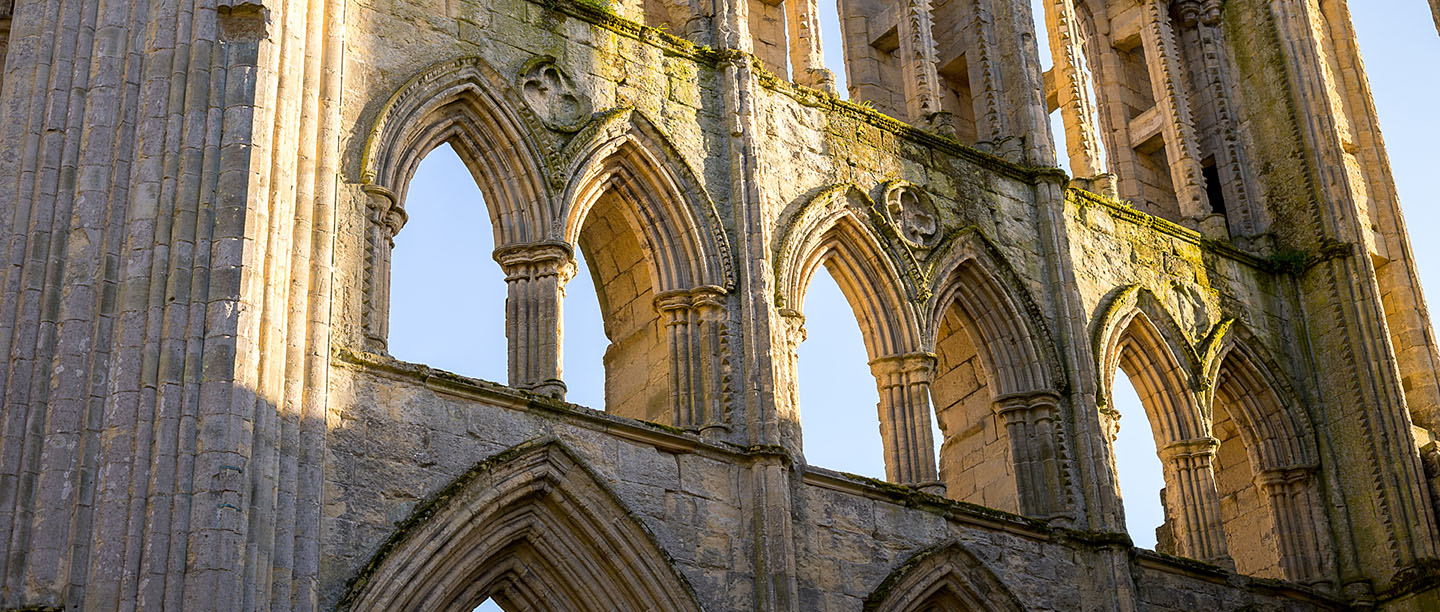 Dramatic arched windows amid the ruins of Rievaulx Abbey
