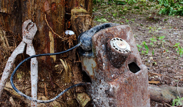 A rusted historic phone and shears
