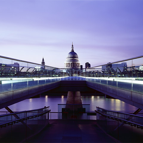 A bridge leads away from the camera and towards St Paul's Cathedral over the River Thames