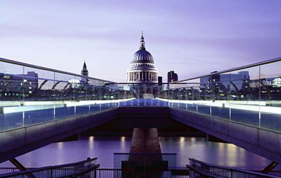 A bridge leads away from the camera and towards St Paul's Cathedral over the River Thames A bridge leads away from the camera and towards St Paul's Cathedral over the River Thames