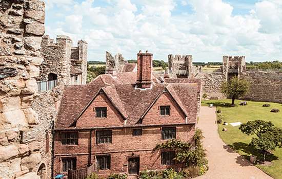 A red brick house surrounded by large castle walls at Framlingham Castle A red brick house surrounded by large castle walls at Framlingham Castle
