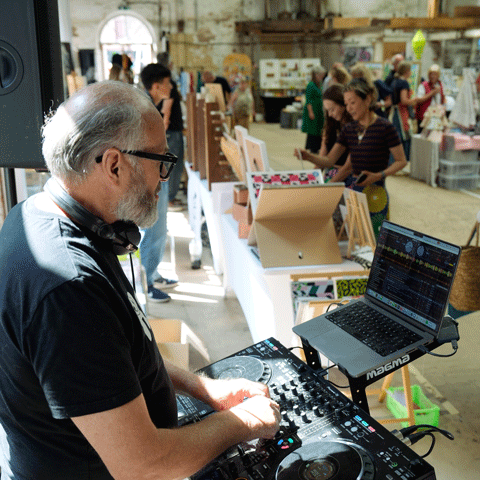 A DJ set at Shrewsbury Flaxmill Maltings within a market space.