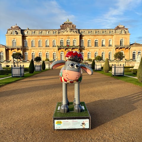 A large painted model of Shaun the Sheep in front of Wrest Park