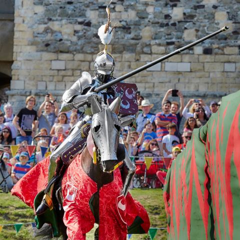 A reenactor Knight on horseback wearing 15th century style armour