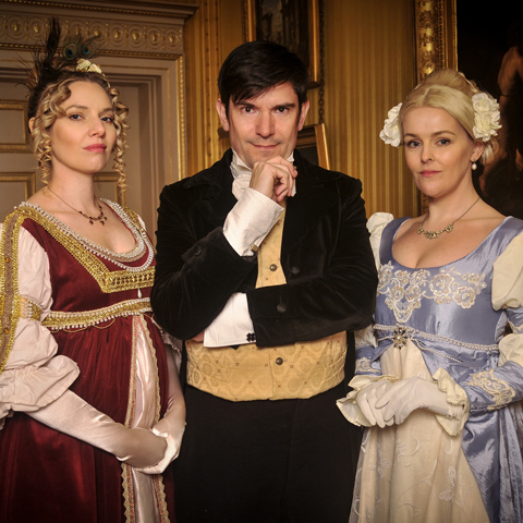 A group of three people dressed in regency clothing.