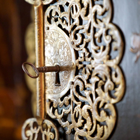 A close up of an old key in a keyhole.