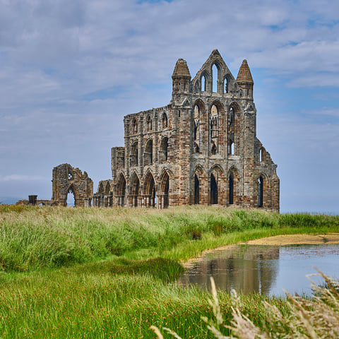 The ruins of Whitby Abbey on a cloudy day.