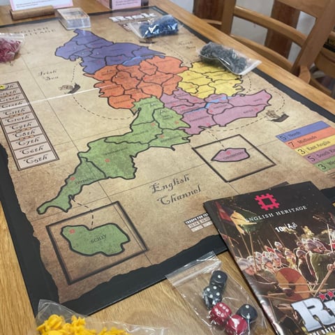 English Heritage Risk the board game laid out on a wooden table.