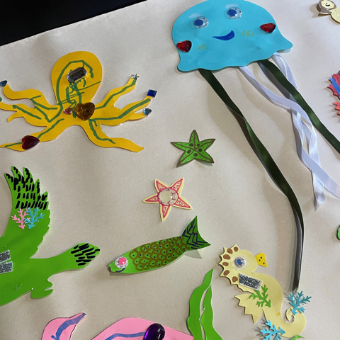 A paper collage of colourful sea creatures.