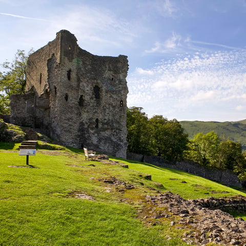An exterior view of Peveril Castle on a sunny day.