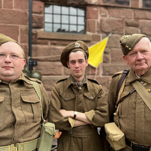 Three men wearing World War Two military uniforms.