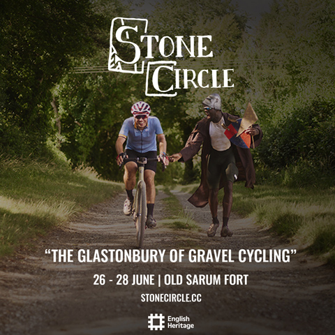A promotional graphic with white bold text reading 'Stone Circle, The Glastonbury of Gravel, 26 - 28 June.' A photo of two cyclists smiling in a wooded area is in the background.