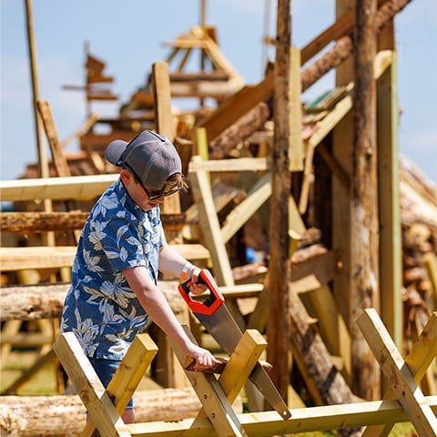 A child sawing wood